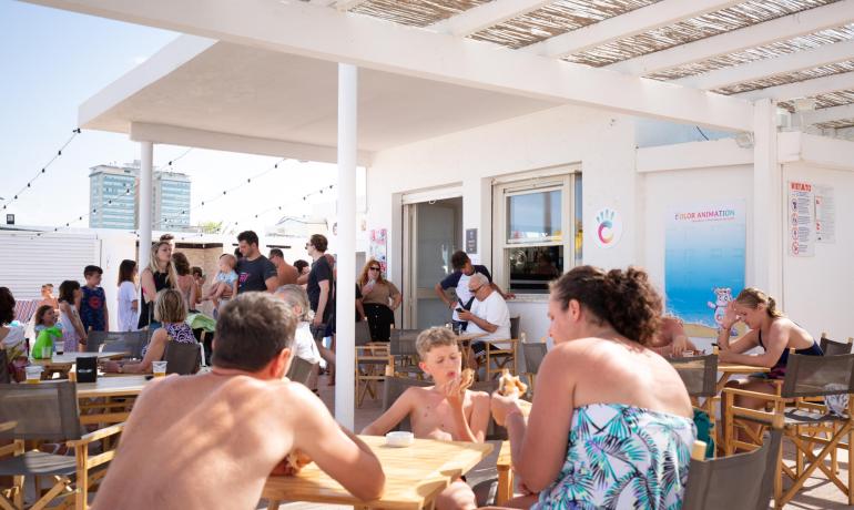 Persone che si rilassano e mangiano in un bar all'aperto.