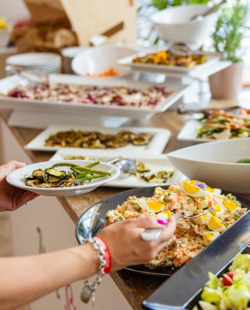 Buffet with colorful and fresh dishes served on a table.